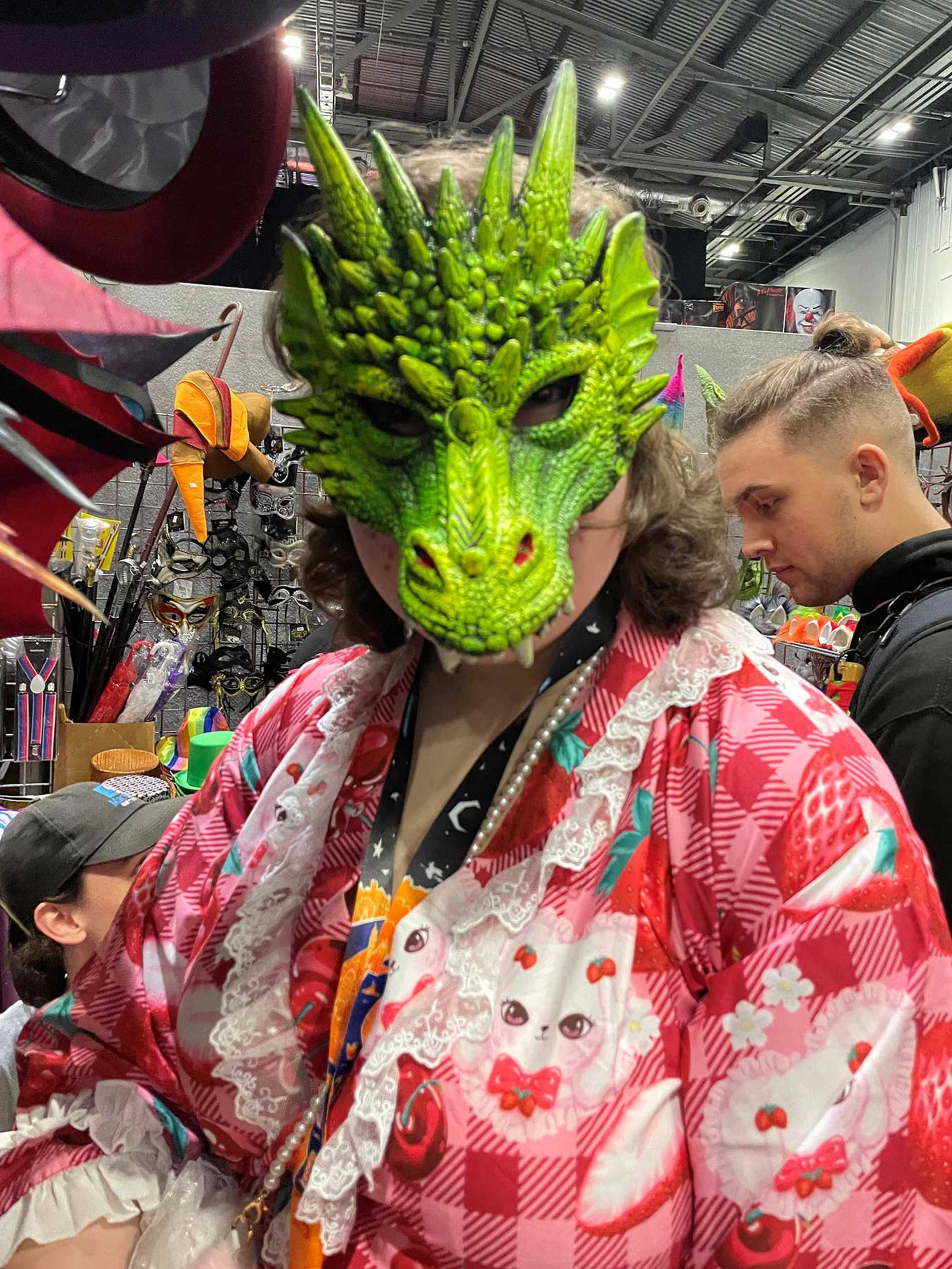Elsie wearing a dragon mask at London Comic Con