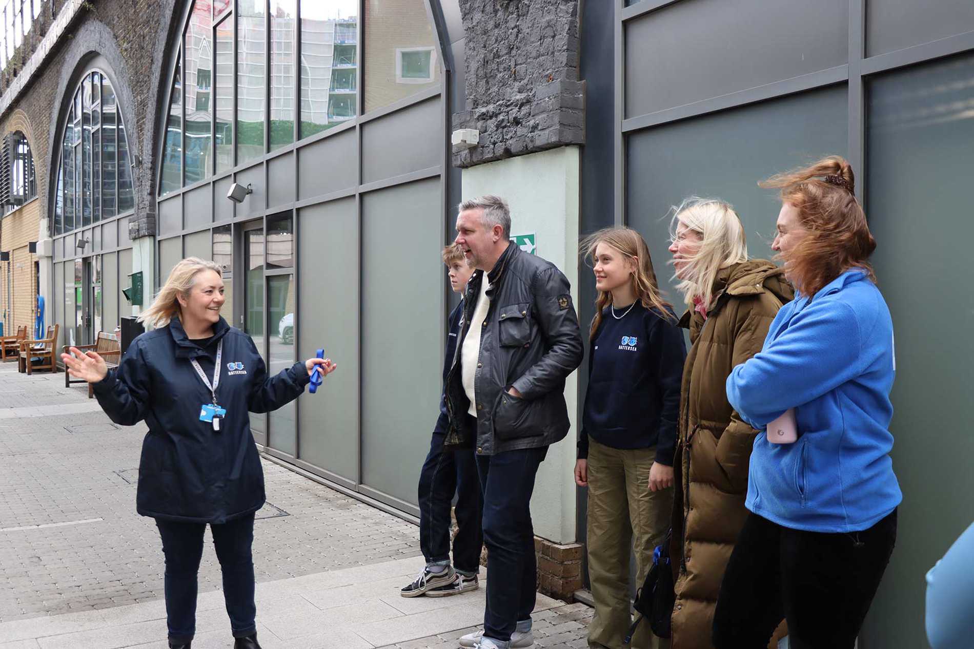 Leila and her family being welcomed to Battersea Dogs and Cats Home by team member Carly.