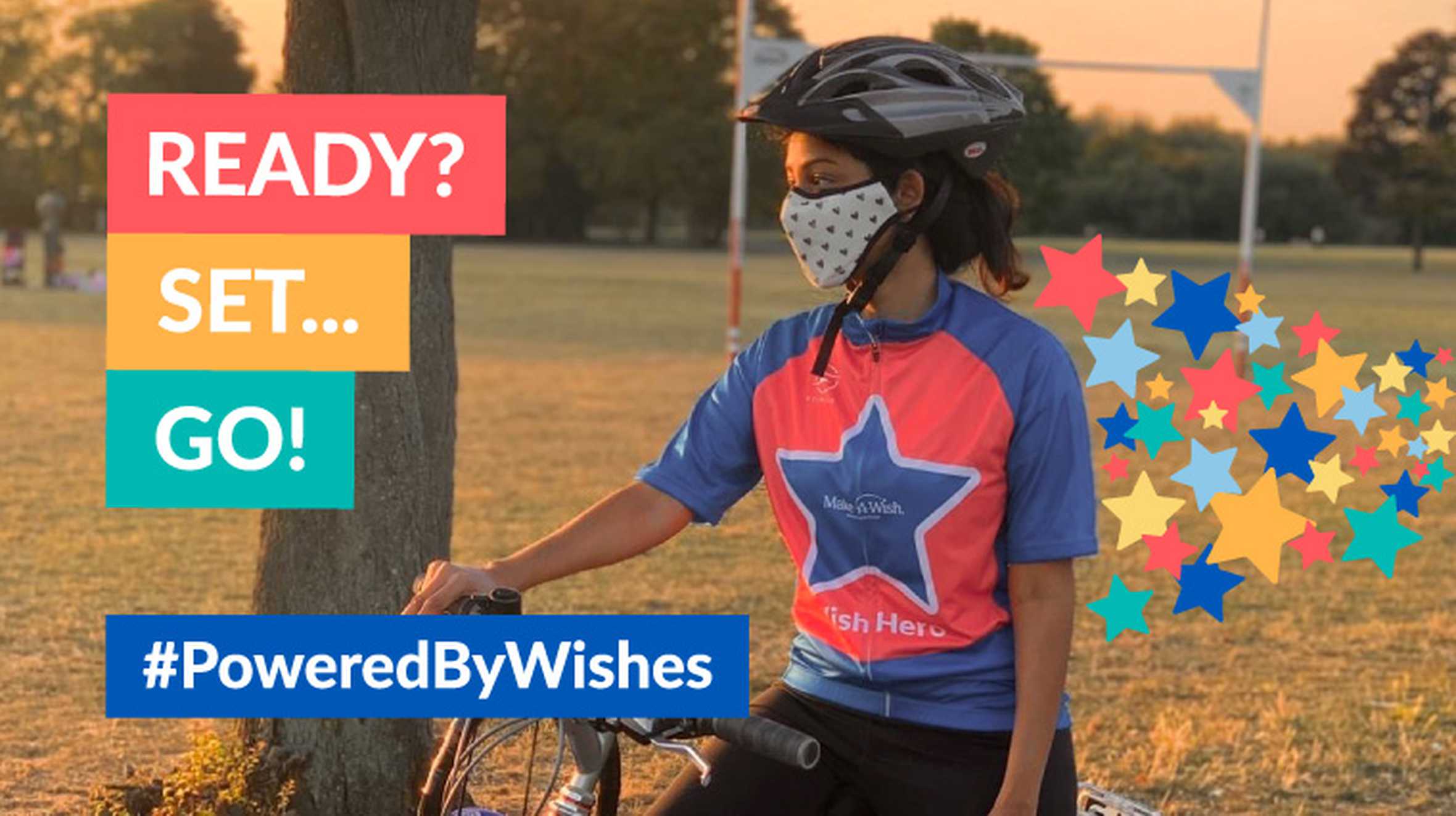 A supporter with their bike, wearing a Make-A-Wish t-shirt.