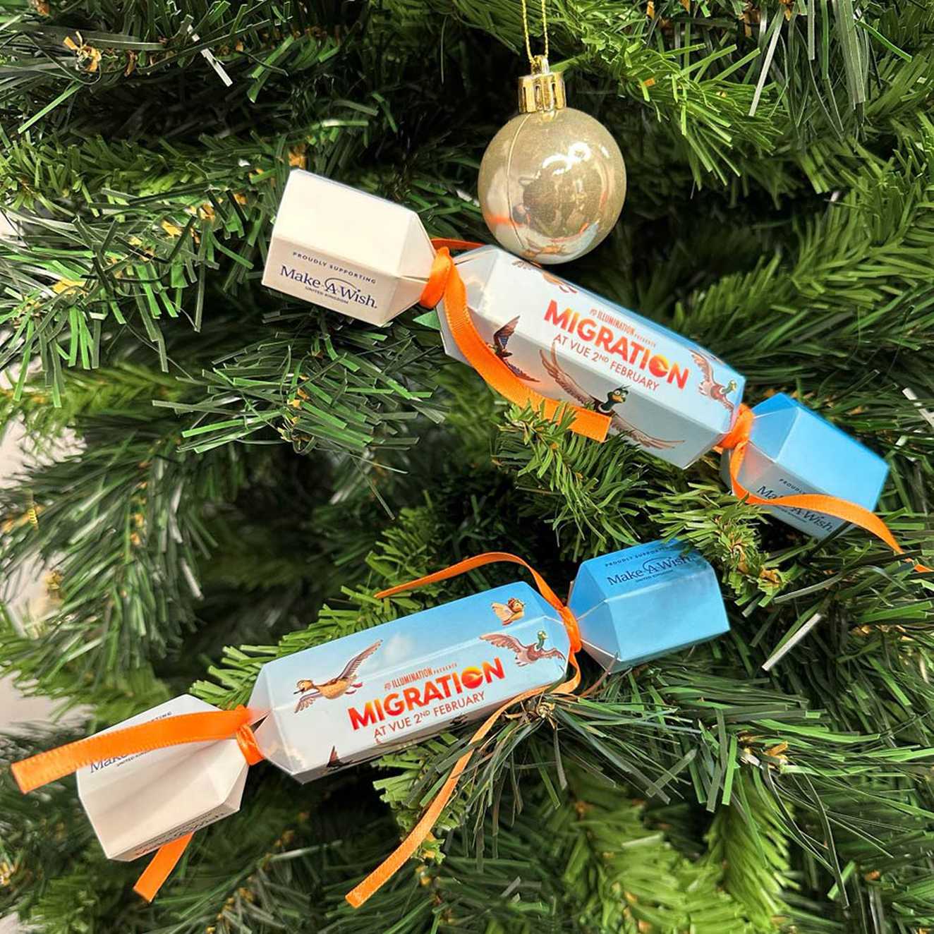 Two #MigrationMovie Christmas 'Quackers' hanging on a tree.