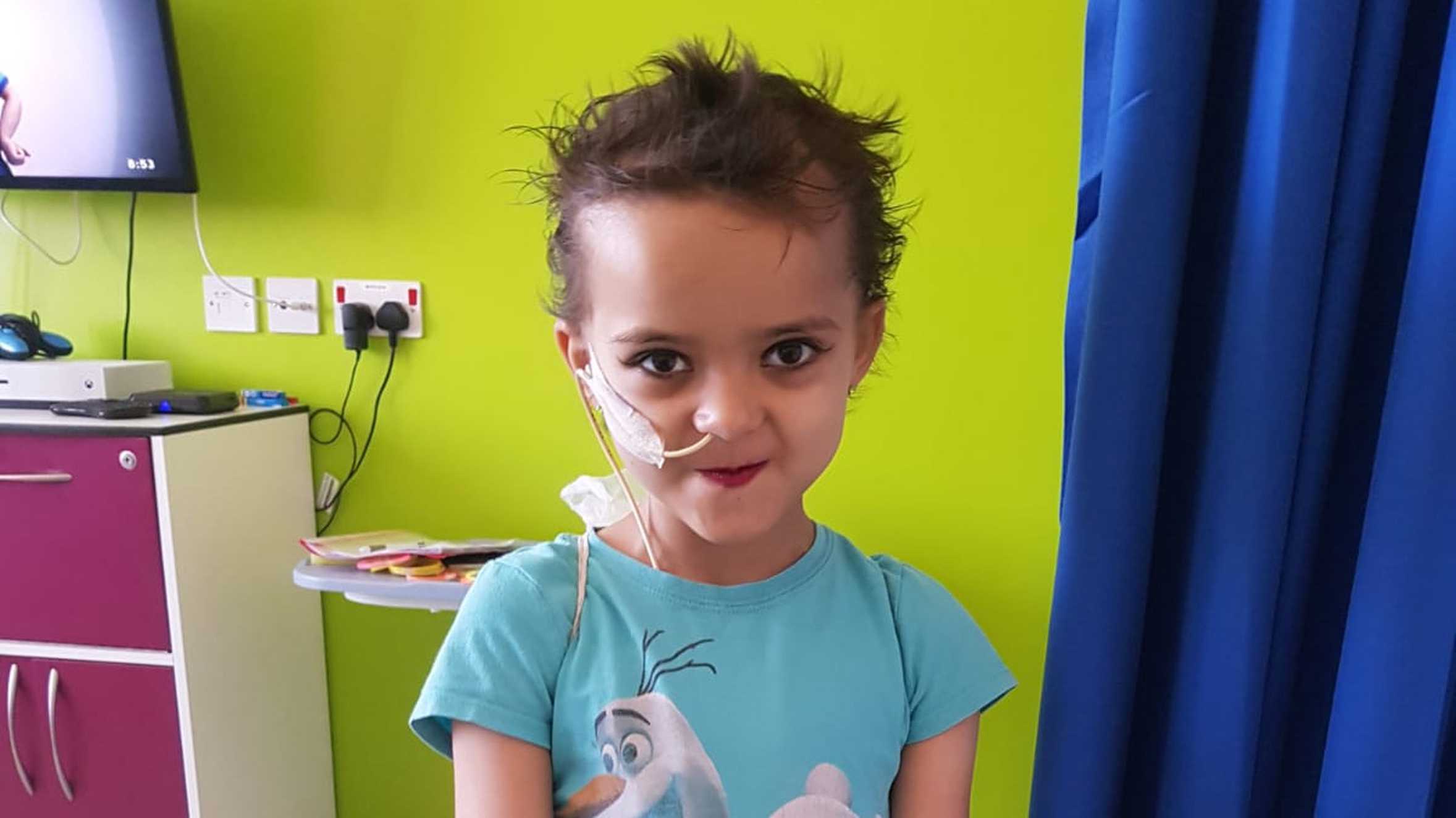 Kelsey in hospital with her bright red lipstick on